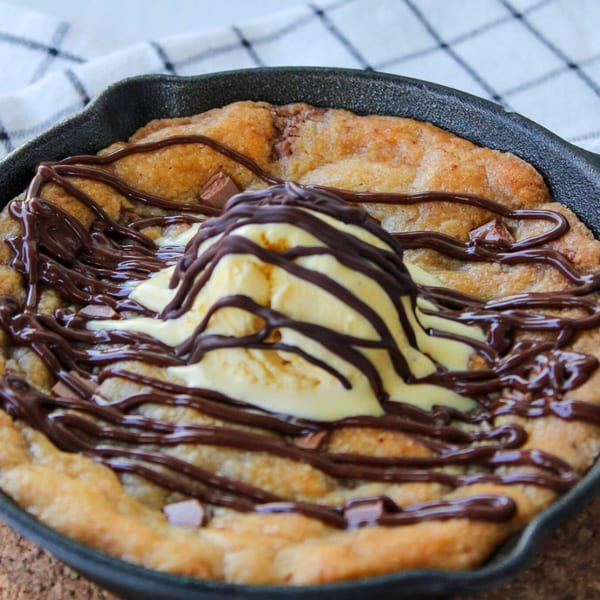 Warm skillet cookie topped with vanilla ice cream and drizzled with chocolate sauce.