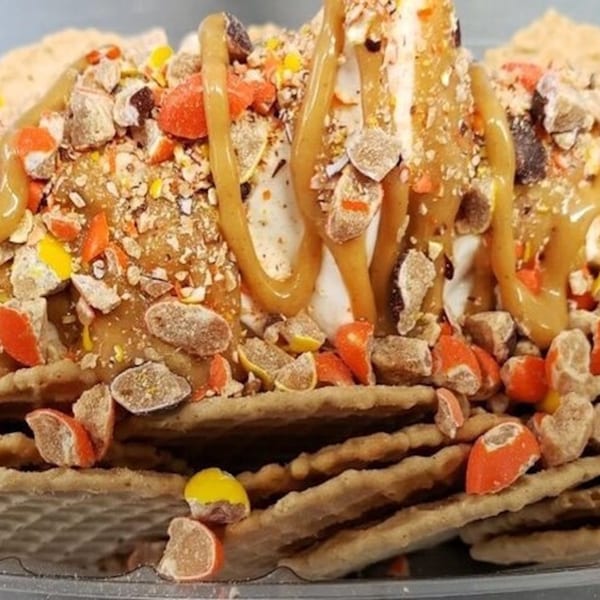 Sabor Ice Cream's dessert with caramel drizzle, candy, and nuts on a bed of waffle crisps.